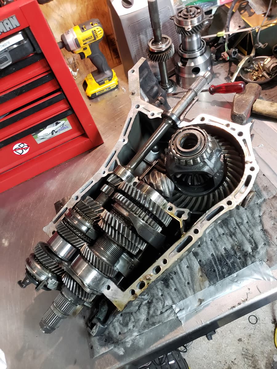 Manual transmission opened up showing gear sets during a rebuild