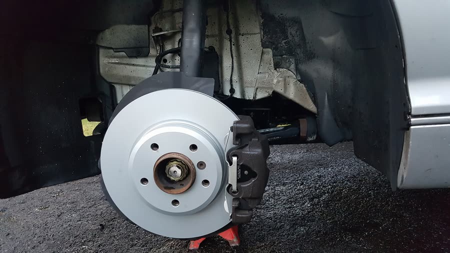 Brand new brake rotor and caliper installed on a vehicle at Just Right Automotive