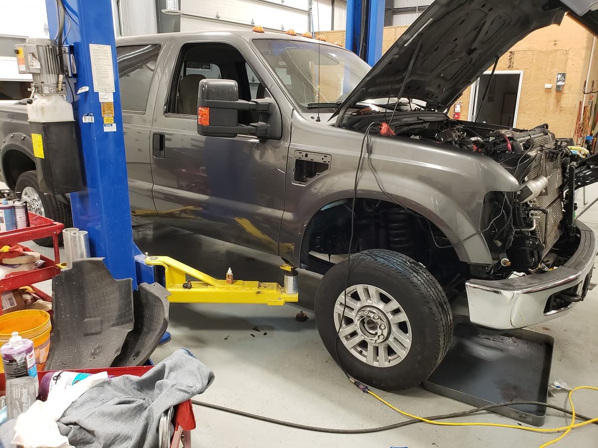 Work truck in the bay receiving engine repair at Just Right Automotive